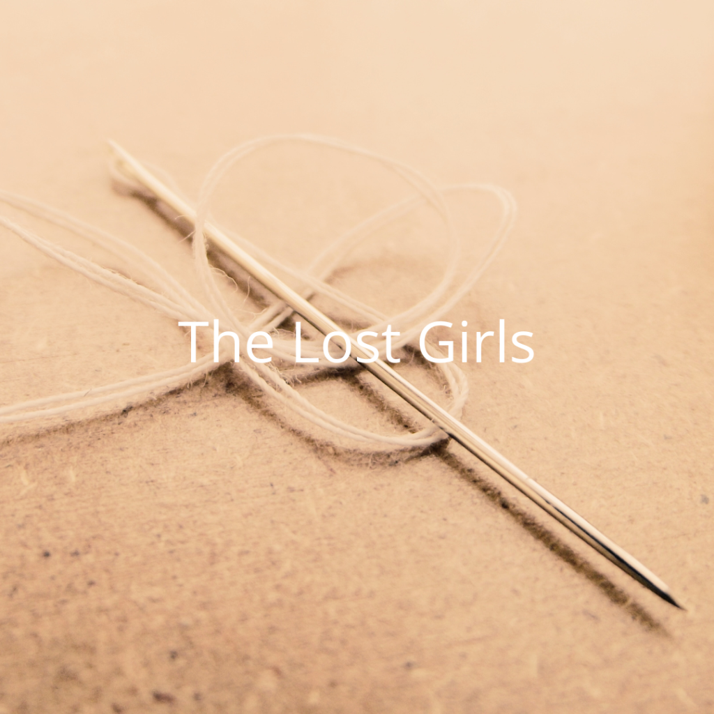 Sepia version of photographic image of a needle and thread laid on a non-descript surface. White text overlay: The Lost Girls